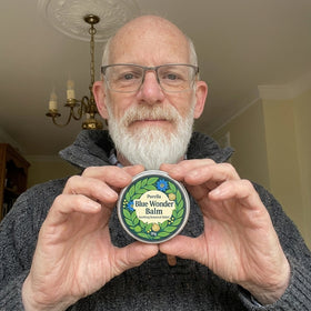 Happy customer holding Purella Blue Wonder Balm