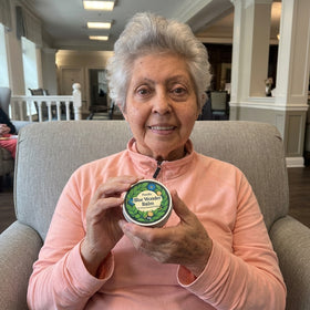 Happy customer holding Purella Blue Wonder Balm